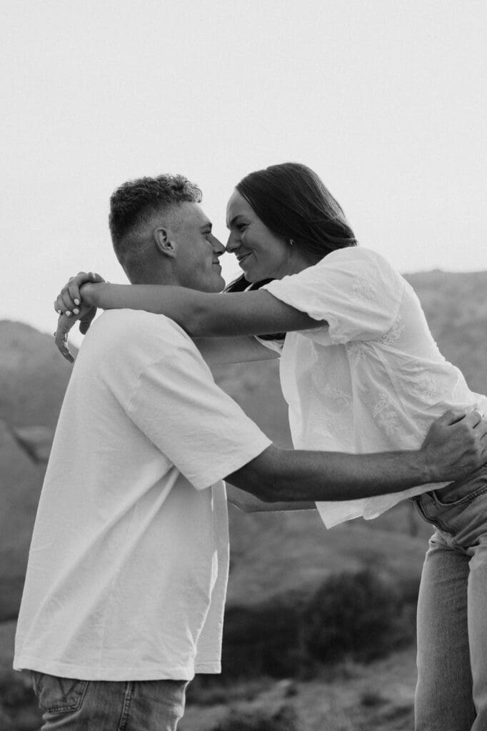 Black and white photo of Jordan and Andrew embracing during their Red Rocks engagement session