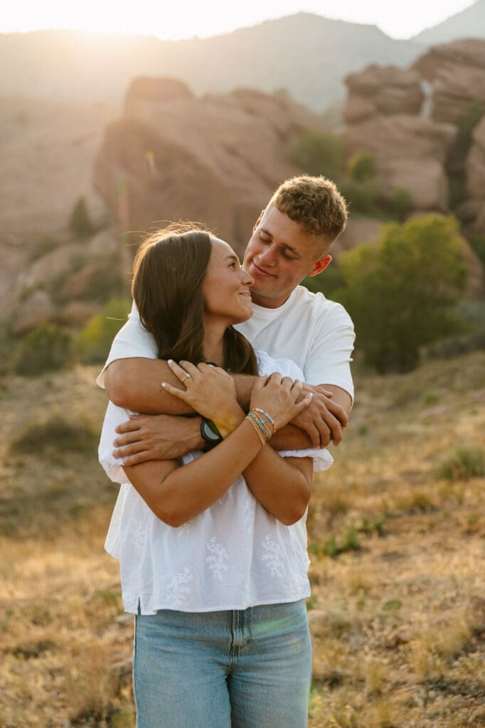 Jordan and Andrew embracing during golden hour at their Red Rocks engagement session