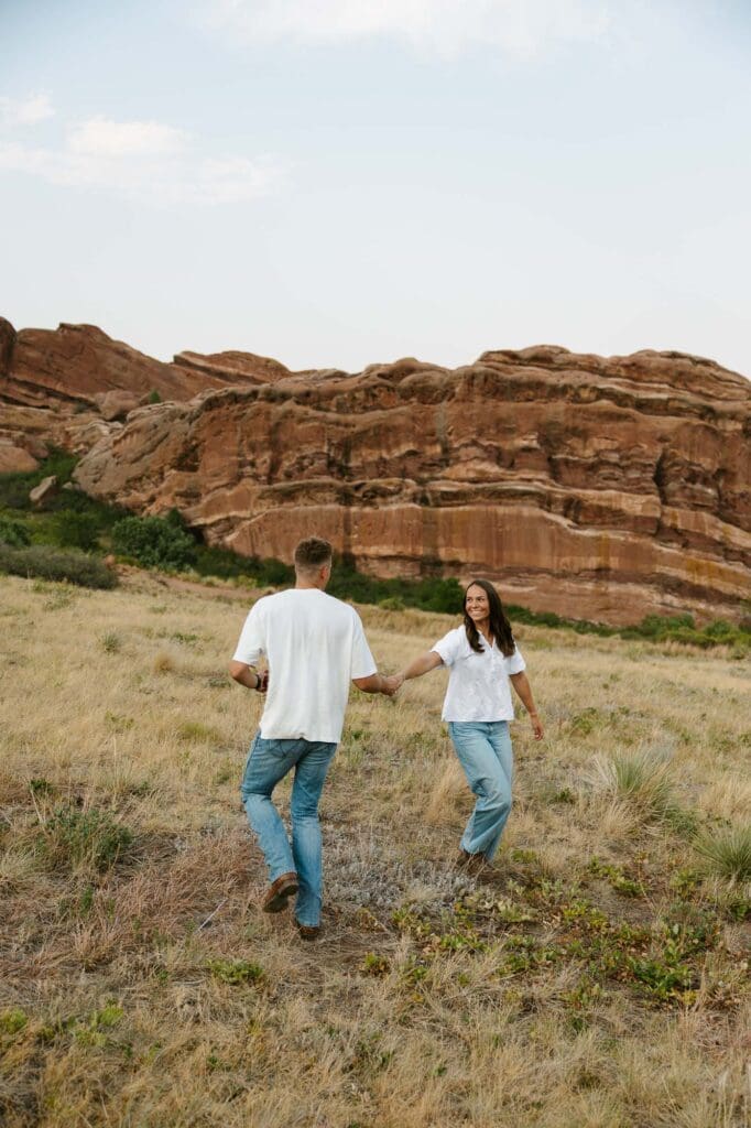 Jordan and Andrew being photographed candidly at their Red Rocks Engagement session