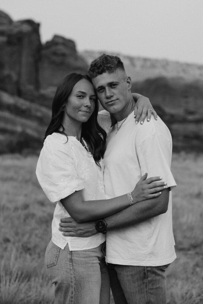 Black and white portrait of Jordan and Andrew embracing during their Red Rocks engagement session